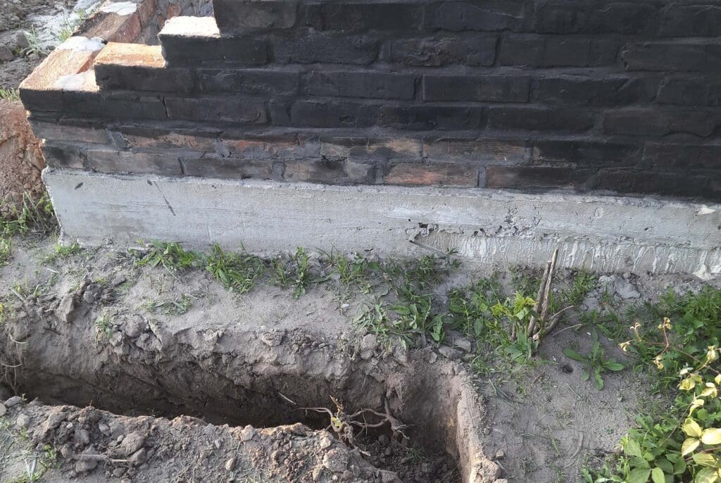 A trench dug in the ground for laying irrigation.